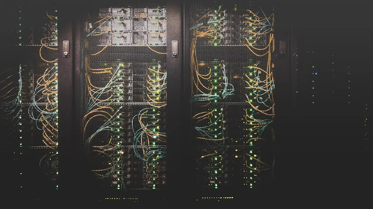 Server racks with dense network cabling, representing large-scale real estate data extraction infrastructure